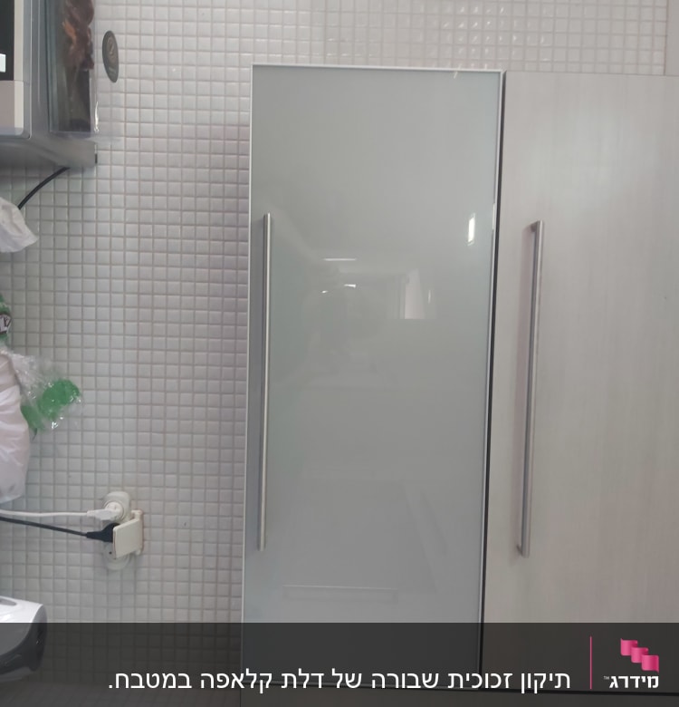דלת זכוכית חלבית עם ידית מתכת במטבח